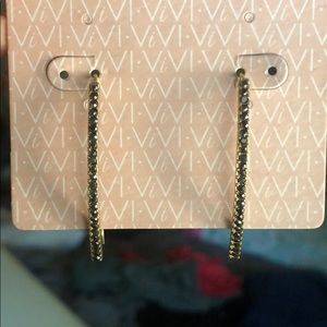 Long gold earrings with black stones